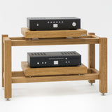 Kunsst rack for audio equipment with a hi-fi amplifier on the top shelf and a CD player on the lower shelf, standing on a white background.