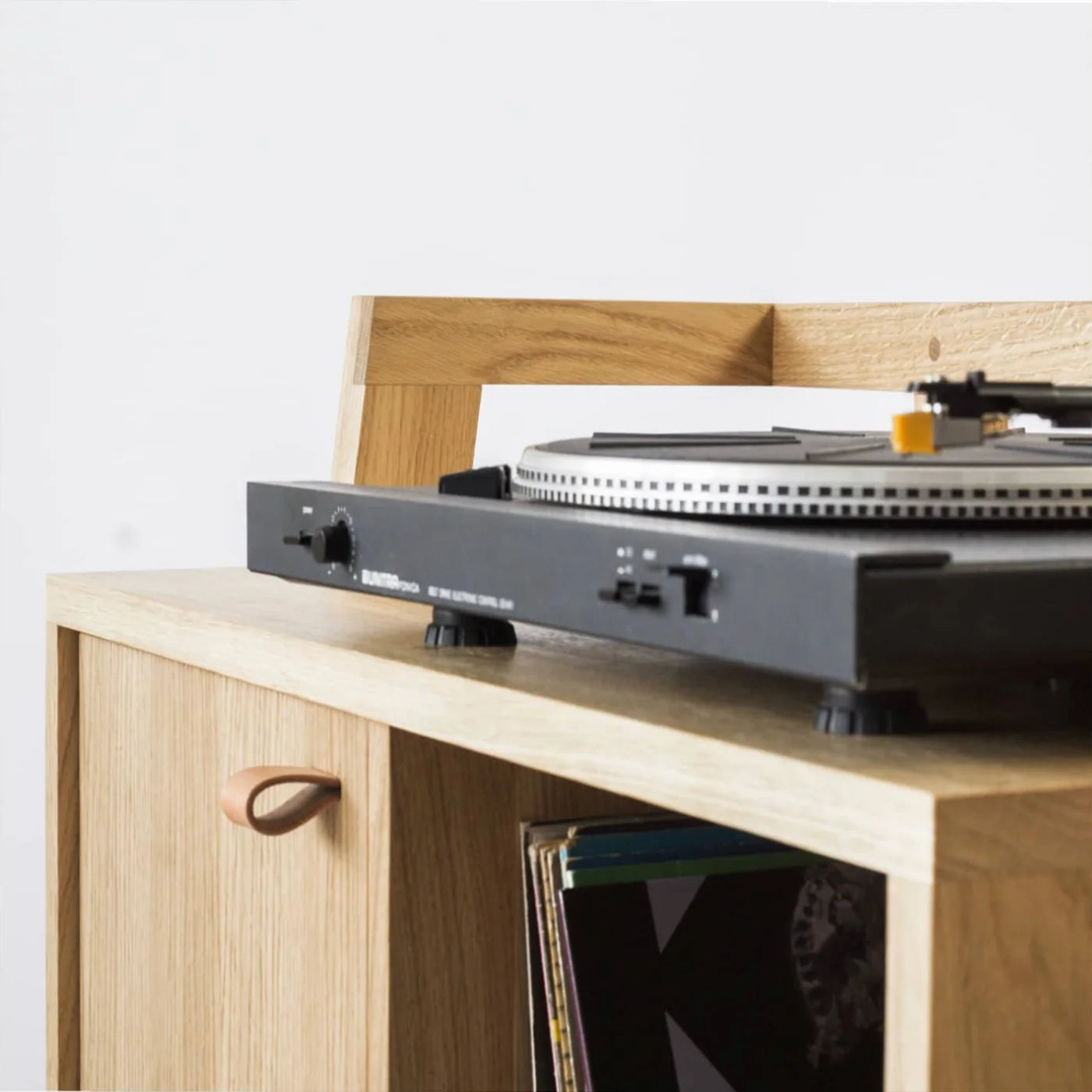 Vintage turntable standing on cabinet for records collection