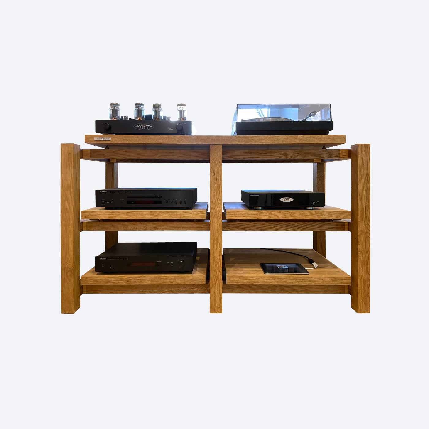 A wooden audio rack with two shelves, the top shelf holding a hifi turntable and lamp amplifier, and other audio equipment, and the bottom shelf holding speakers.