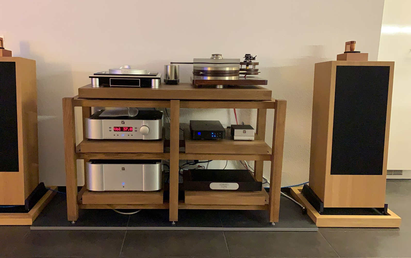 A three-tier audio system rack holding a Luxman L-505Z, IsoTek Mini Sub power conditioner, Linn Sneaky Music DS, Hegel V1 phono preamp, two tube amplifiers and an Oracle Audio Delphi turntable