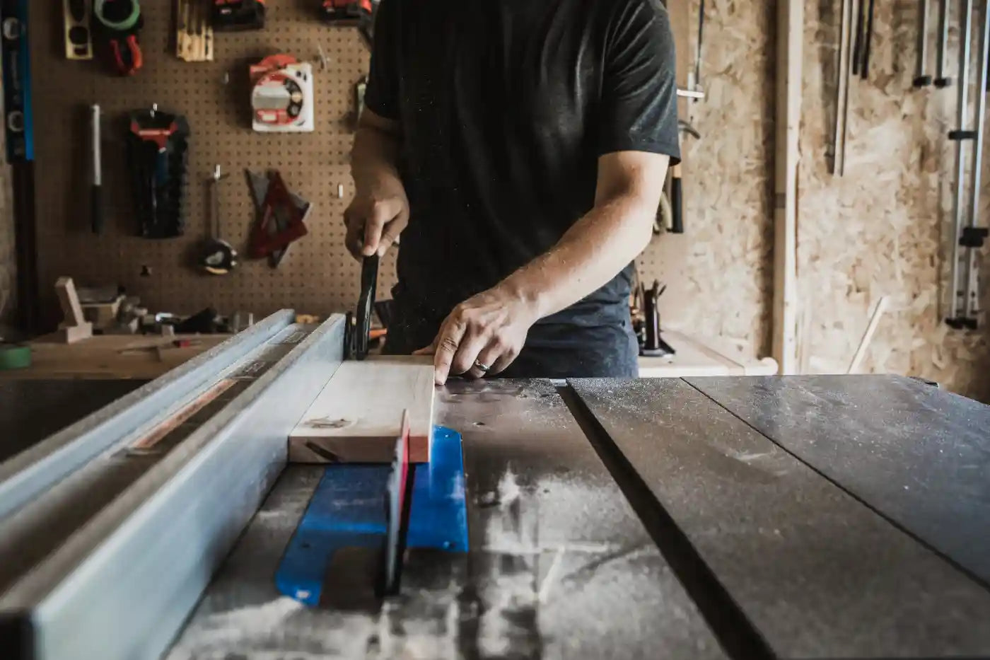 Carpenter using a table saw in a workshop setting