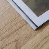 Kunsst- solid oak desk top with drawer under wooden desk . Detail on magazine laying on kunsst desk for home office or bedroom 