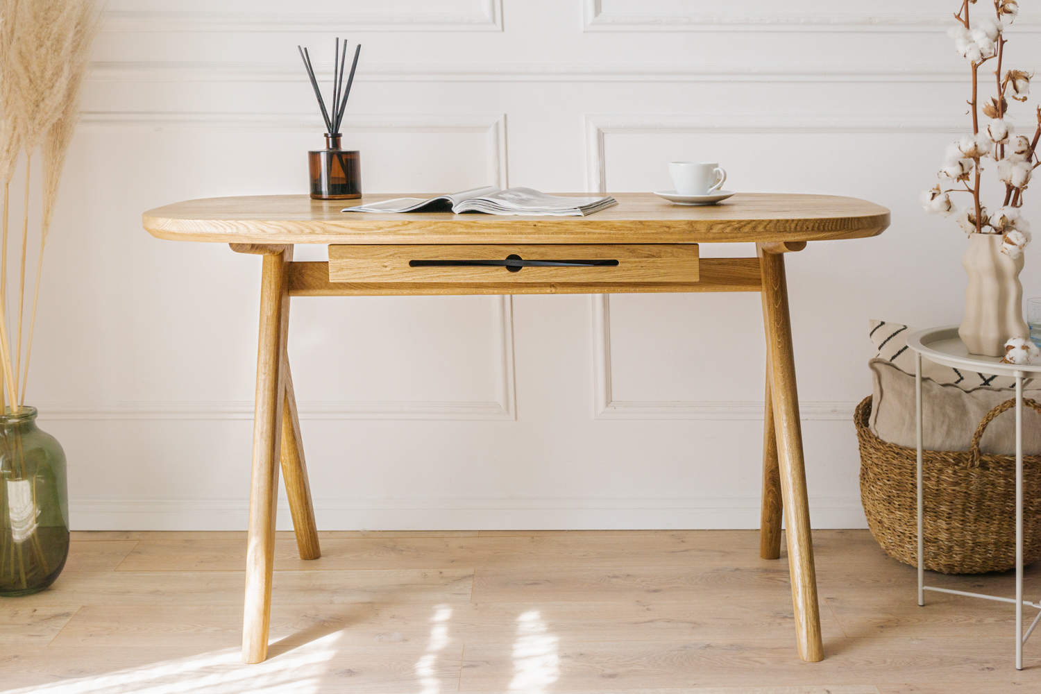 Kunsst solid wood desk with drawer is showcased in a classic office on natural wood flooring, backed by a white wall with elegant mouldings. 