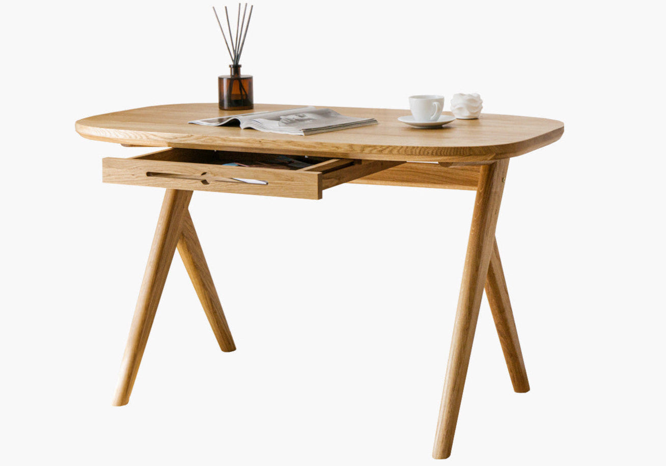 Designer solid wood desk for small spaces  with  magazine and two cups on oak desk top standing on white background
