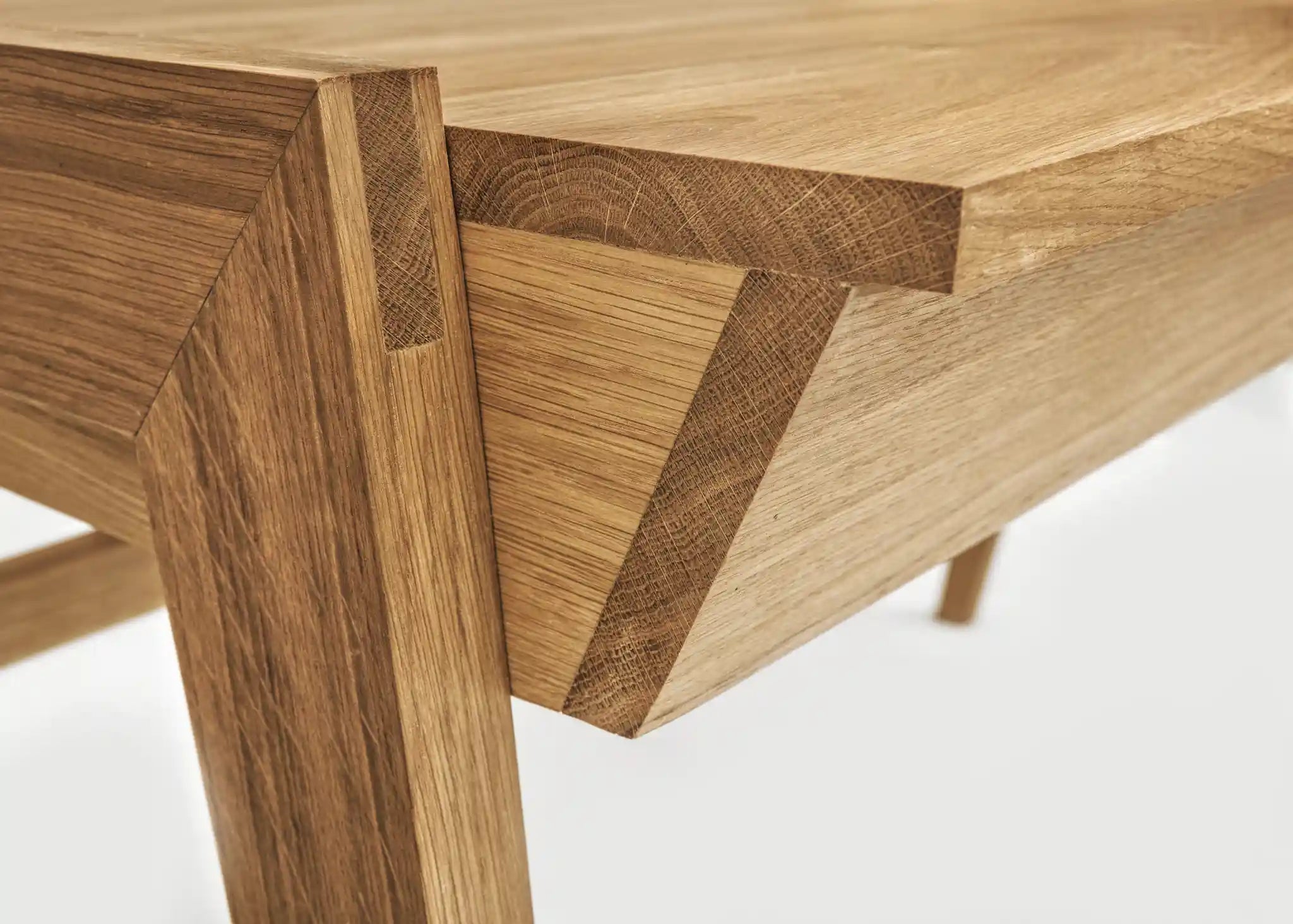 Close-up of a real wood desk with drawer with visible oak grain and joint details on a white background 