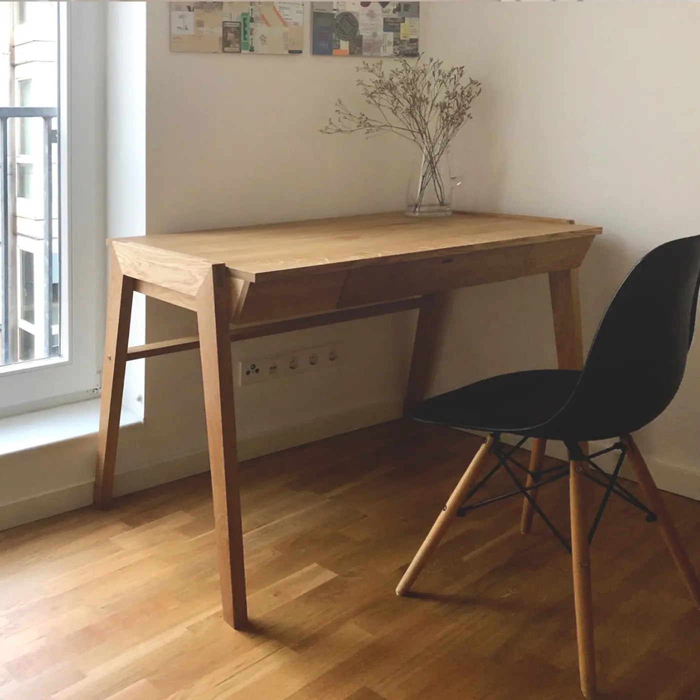 Designer writing desk with oak table top standing in the corner of home office room